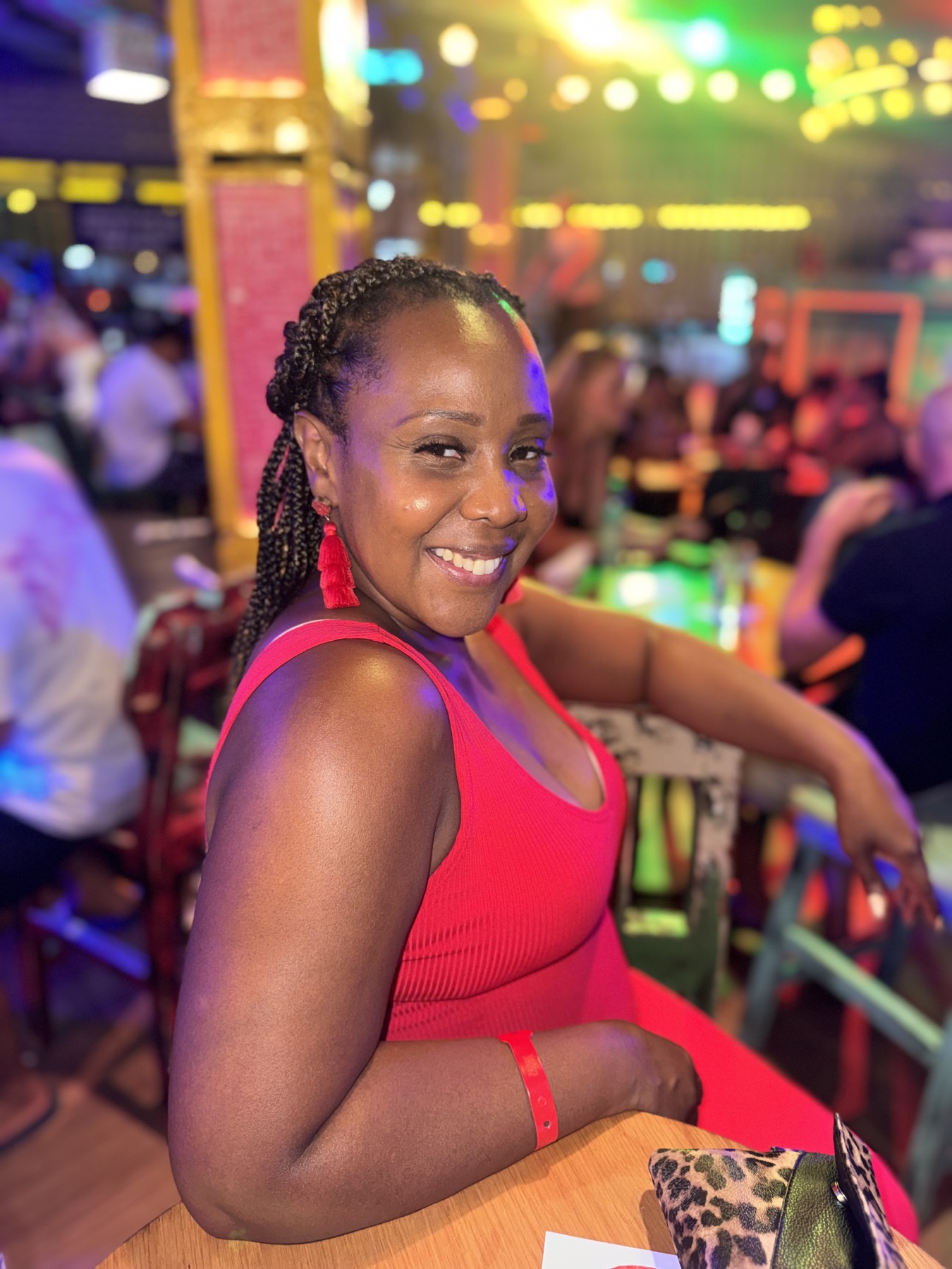 Beatrice smiling in a red dress