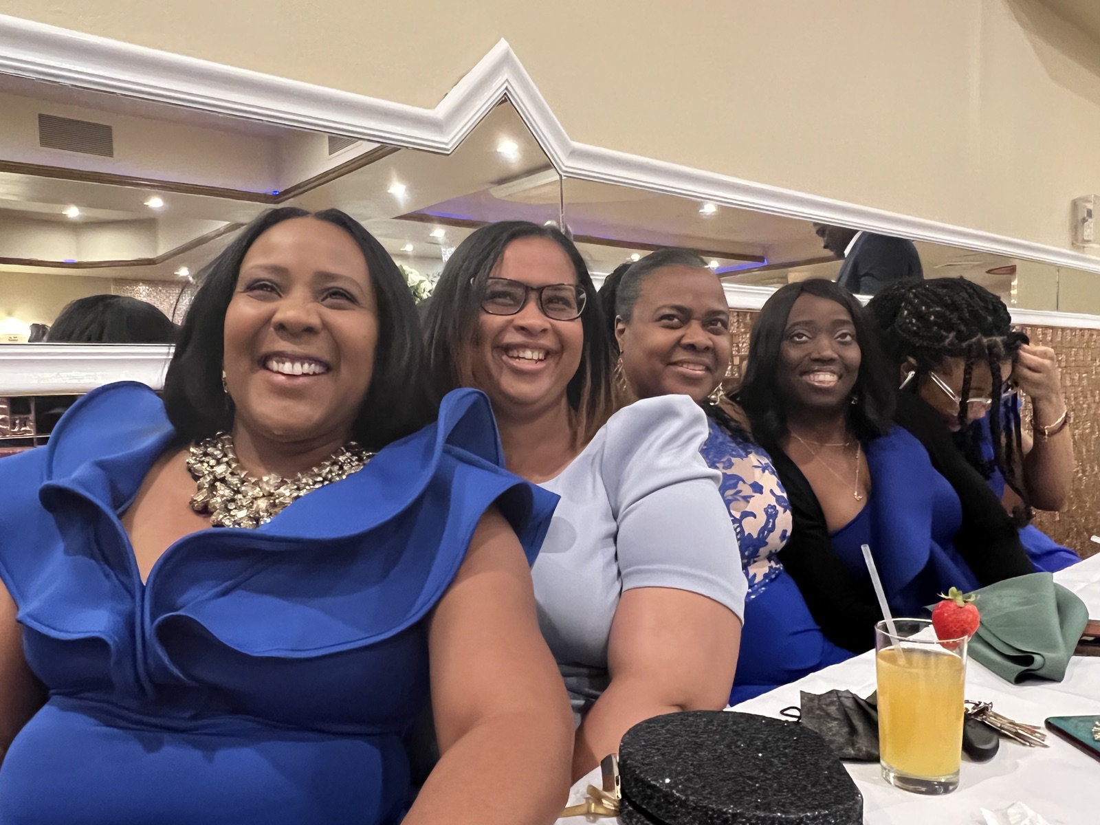 Beatrice laughing with friends at a celebration