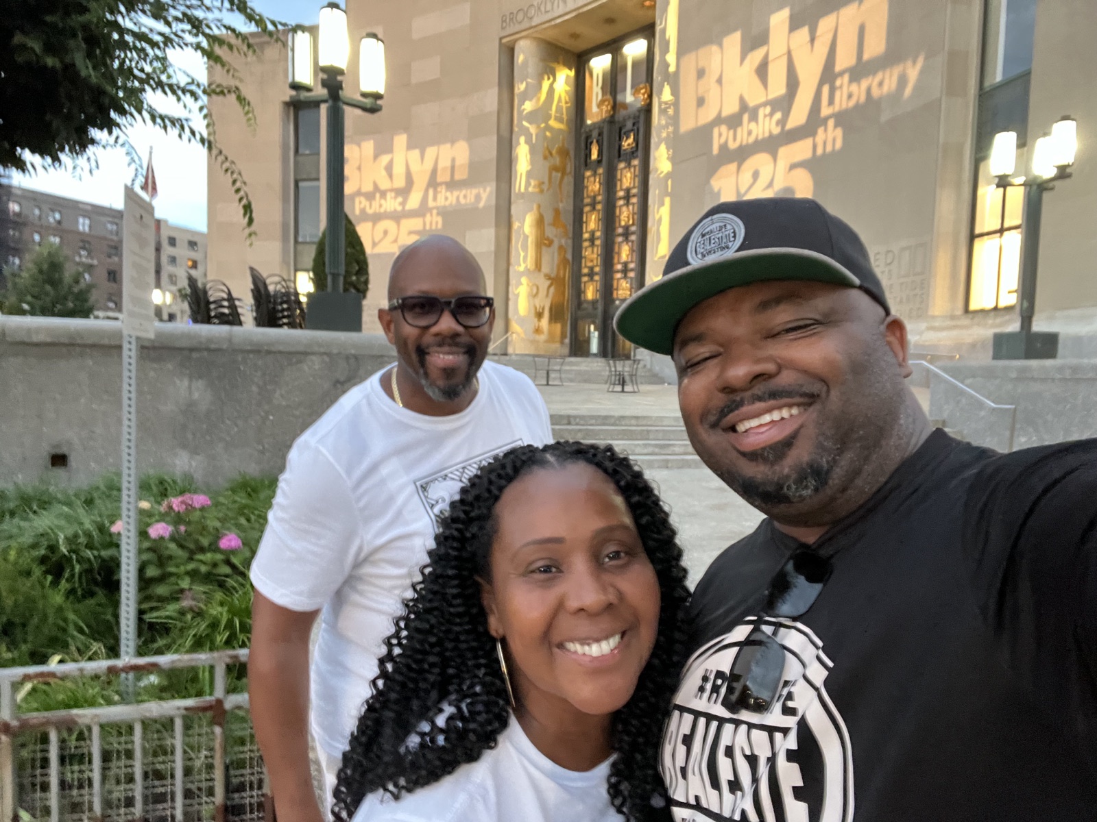 Beatrice smiling with family outside the Brooklyn Public Library